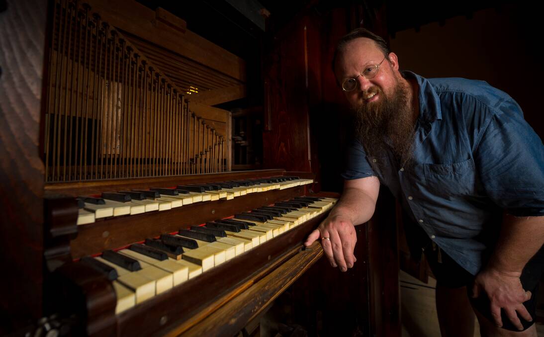 Antique beauty: Organ builder Justin McDonnell with the 1889 pipe organ at Creswick Anglican Church. A recital celebrating the organ's arrival will be held on April 16. Picture: Dylan Burns