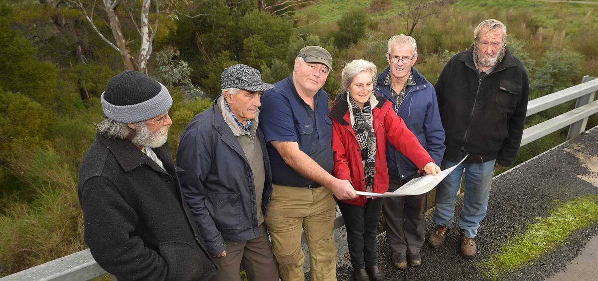 What's in a name: The Jim Crow Planning Group and Cr Bill McClenaghan peruse a map of Indigenous place names, alongside the creek in question. Picture: Dylan Burns