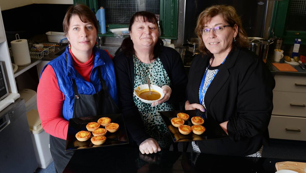 Warming hearts: Volunteers of Creswick Community Dining Alison Andrew, Judy Micallef and Joanne Bott cook up a storm. Picture: Kate Healy