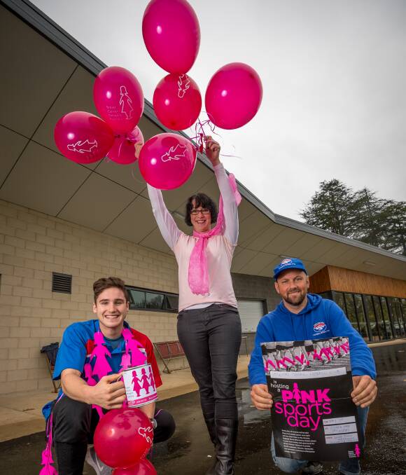 Pinking it up: Daylesford football player Joel Cowan, club treasurer Lyndall Jenkin and senior coach Marcus Goonan ready in fuschia tones for its annual Mother's Day sports event. Picture: Dylan Burns