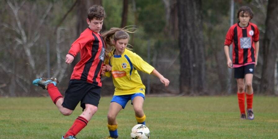 CHARGE: Sean Armstrong defends for Daylesford U13s, that was fresh from a bye this week. They played an outstanding game of defense and attack against Bacchus Marsh Blue. Picture: Contributed 