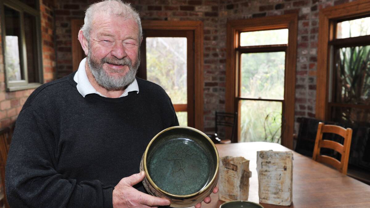 Clunes Ceramic Award chair Graeme Johnstone with some local pieces. Picture: Julie Hough 