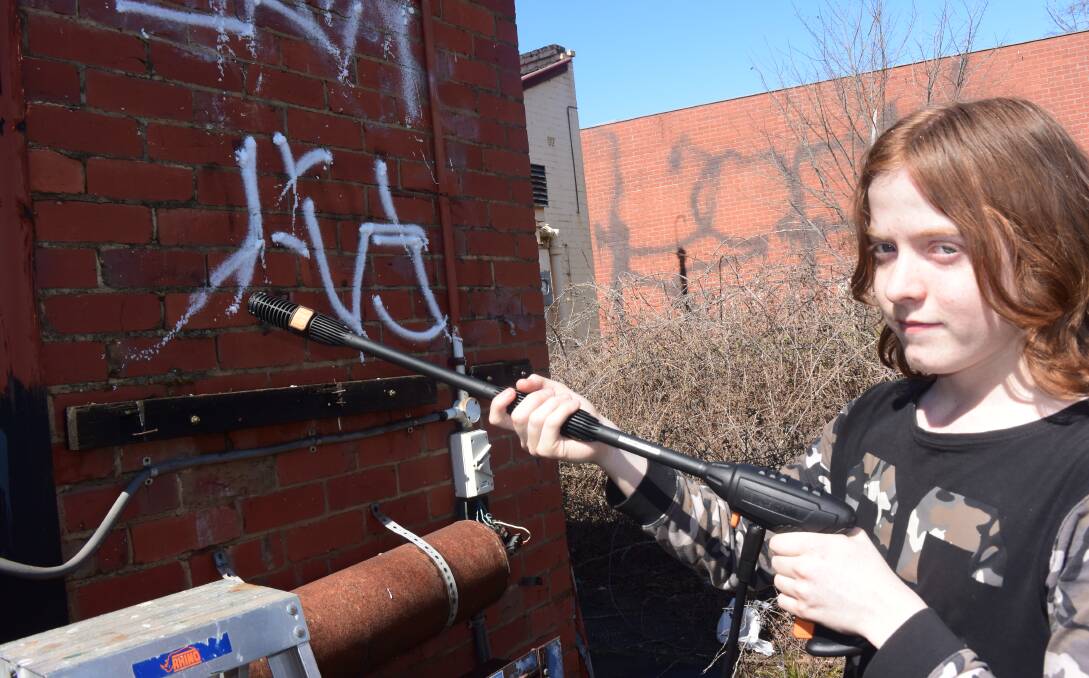 TIME TO CLEAN UP: Creswick's Asher Kuhn, 14, was one of the volunteers cleaning up the old British Hotel on Saturday. Picture: Olivia Shying