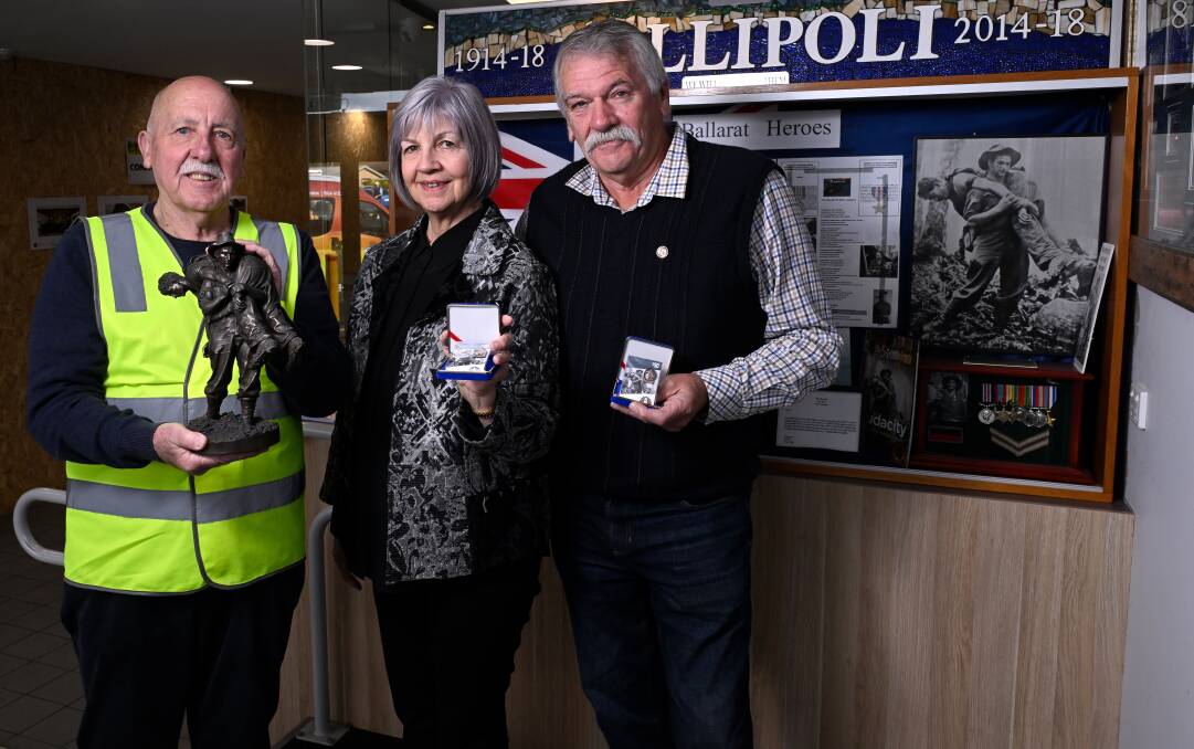 Ballarat RSL veterans advocate Phil Carter with Corporal Leslie "Bull" Allen's children Eleanor Johnson and Leslie Allen, holding the Anzac Appeal badges featuring their father. Picture by Adam Trafford