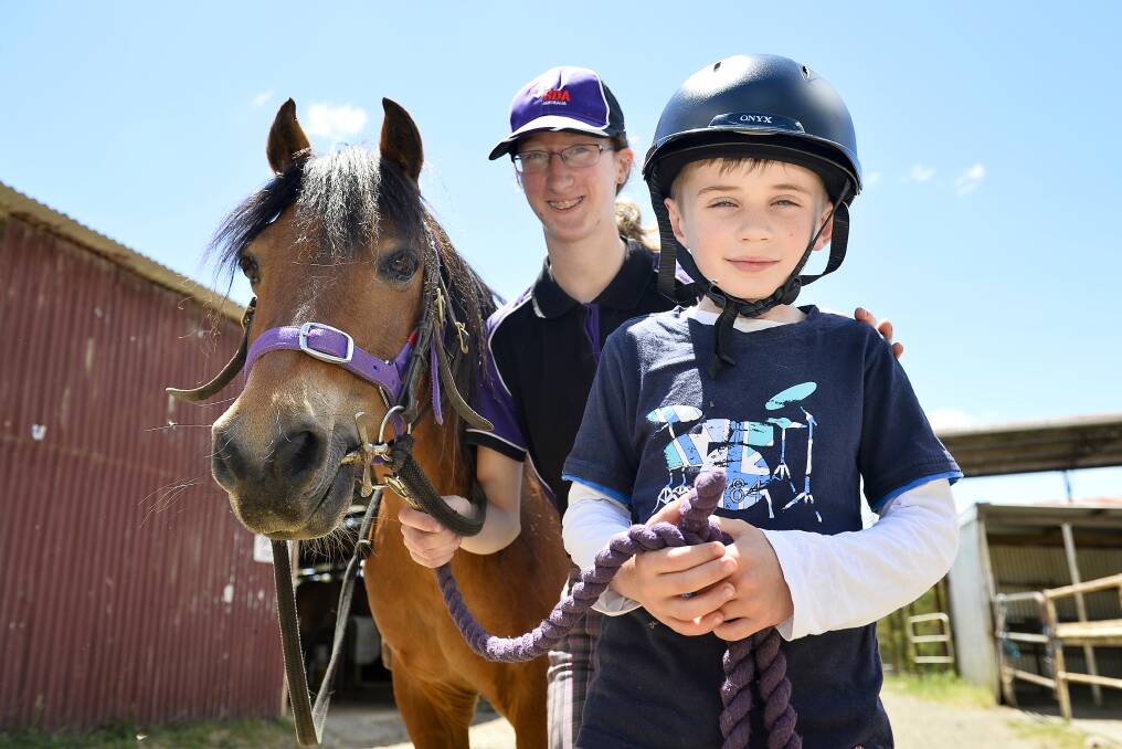 New uniforms: Riding for the Disabled volunteer Ashley Krive and seven-year-old rider Thomas Quartermain after the announcement of a new grant for the organisation.  Picture: Dylan Burns. 