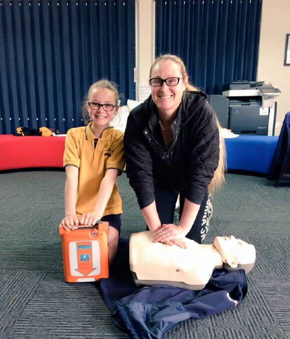 Lifesaving lessons: Clunes Primary School grade 6 pupil Ruby Hipwell teaches her mother Sally Grimwood how to perform CPR as part of Ambulance Victoria's Restart a Heart day.  