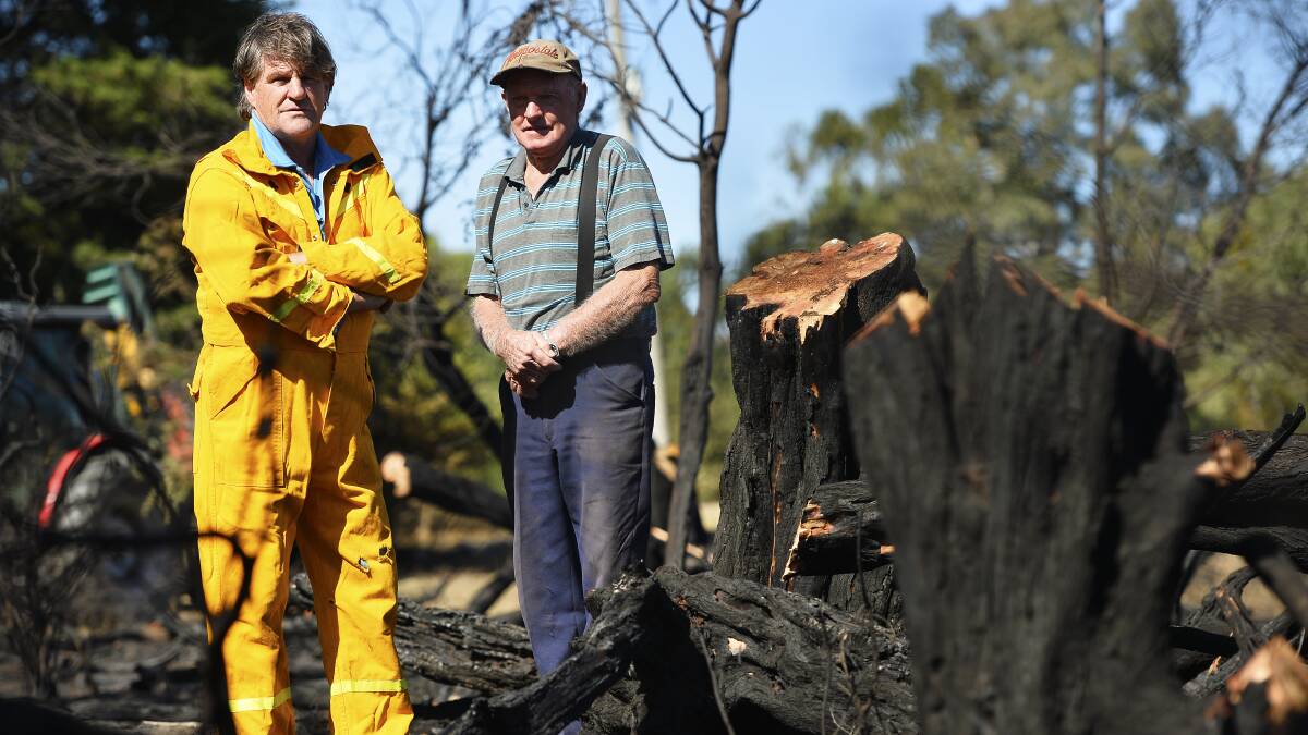 Not impressed: Campbelltown residents Chris Culvenor and Ewen Campbell inspect the land along Creswick-Newstead Road which was burnt last week.  Picture: Dylan Burns. 