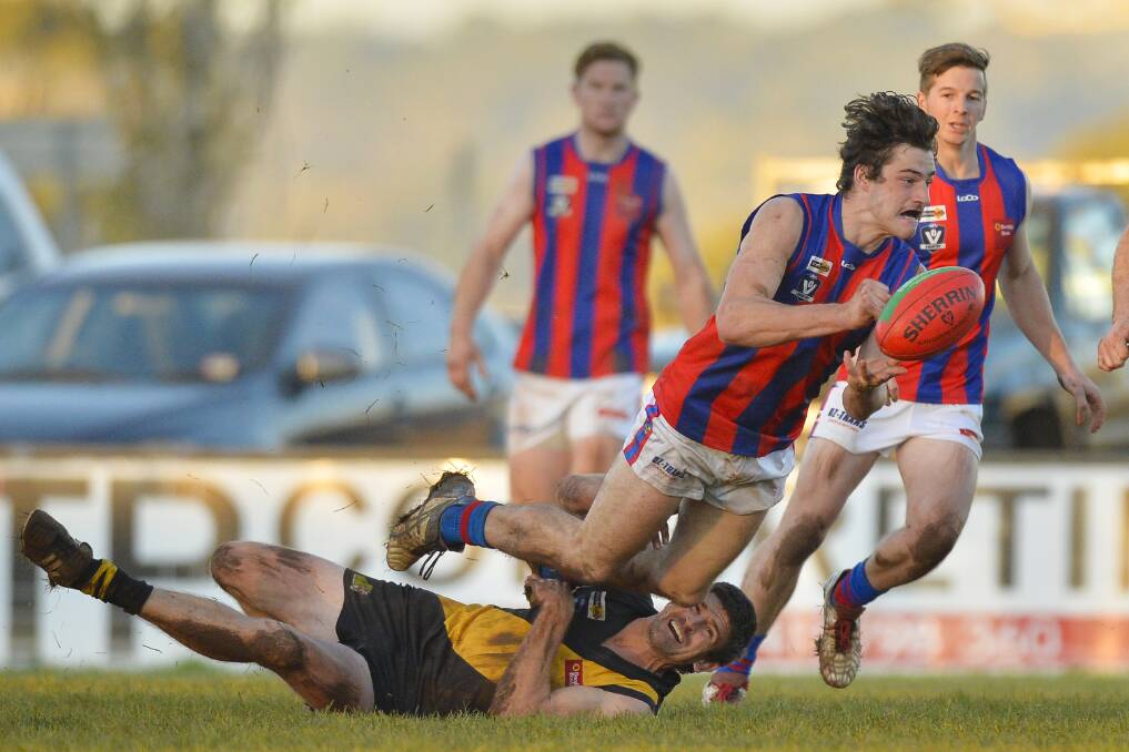 QUICK HANDS: Hepburn's Jacob Brown dishes out a handball under Tigers pressure. He kicked three goals as the Burras amassed a 62-point victory. Picture: Dylan Burns