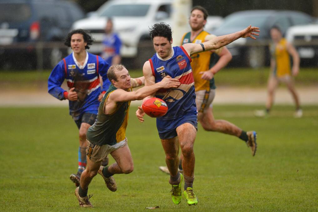 PRESSURE: Gordon's Mick Nolan lays a tackle on Daylesford opponent Joel Cowan during Sunday's clash at Victoria Park. Picture: Dylan Burns.