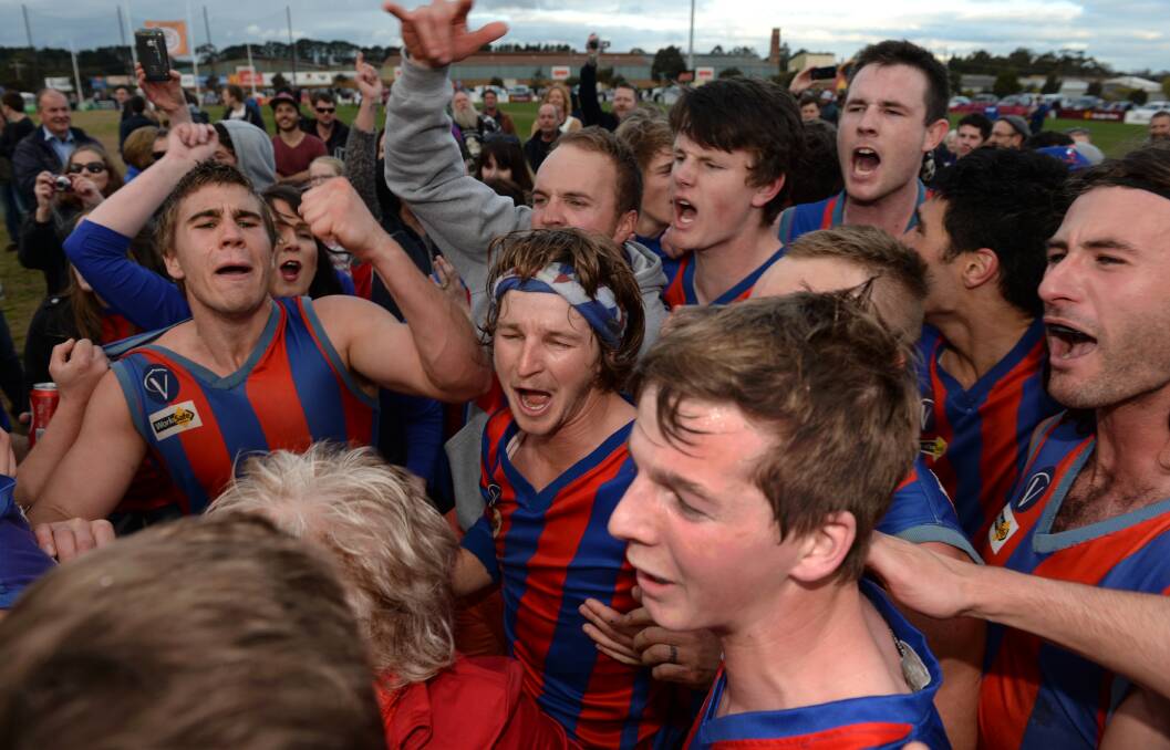 HAPPY DAYS: Hepburn players and supporters celebrate the 2014 senior premiership following the grand final win over Buninyong.