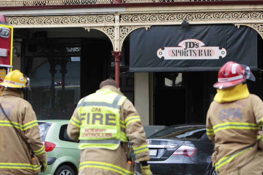 Firefighters on the scene of a fire believed to have started at JD's Sports Bar. Picture: Luka Kauzlaric.