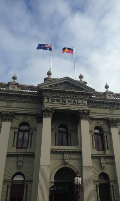 Flying the flag: The Aboriginal and Australian flags at full mast alongside one another atop the Daylesford Town Hall following a special ceremony on Sunday.