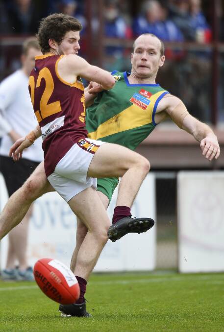 COLLISION: Patrick Fitzgibbon (Redan) and Stephen Clifton (Lake Wendouree) go hard at it in a bone-crunching encounter at the Eastern Oval on Sunday.. Photo: Dylan Burns