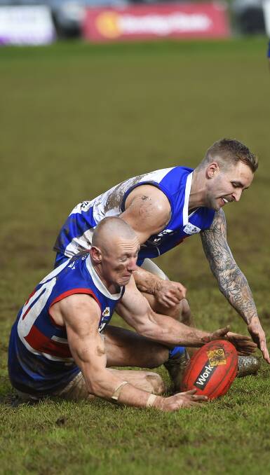 TUSSEL: Ashley Ballinger (Waubra) and Ken Cummings (Daylesford) fight it out in an elimination final at Bungaree on Saturday. Picture: Luka Kauzlaric