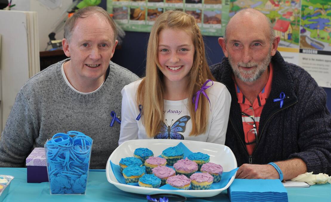 SPEECHMAKER: Tiana, 10, is passionate about raising awareness of Huntington's disease which her grandpa Bernie Collins, left, and great uncle Tim Collins, right, have both been diagnosed with. Picture: Lachlan Bence