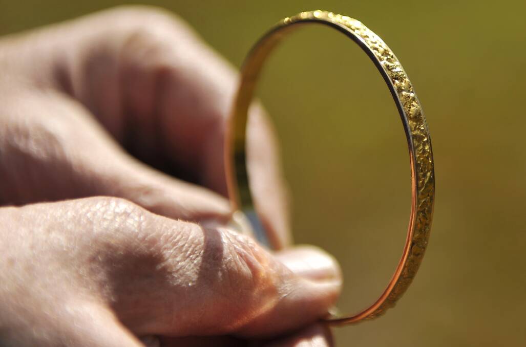 JEWELRY: Creswick local gold prospector Frank Wallis makes gold jewelry from a workshop at his home. He made this gold bangle for his wife Nola. Picture: Dylan Burns. 