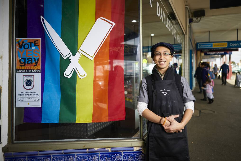 RAINBOW SUPPORT: Daylesford Meat Co's Jeffrey Chua with rainbow flags in support of gay marriage in the lead up to the national postal survey. Pictures: Luka Kauzlaric.