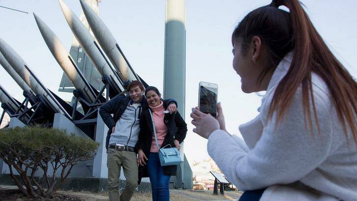 Tourists pose in front of  model missiles, including a North Korean Scud-B, at the War Memorial of Korea in Seoul. North Korea's long-range rocket launch is considered by the West to form part of its efforts to develop intercontinental ballistic missile technologies. Photo: Han Myung-Gu