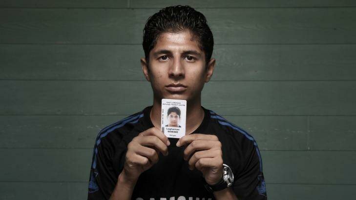 Loghman Sawari with his identify card in 2015. Photo: Andrew Meares