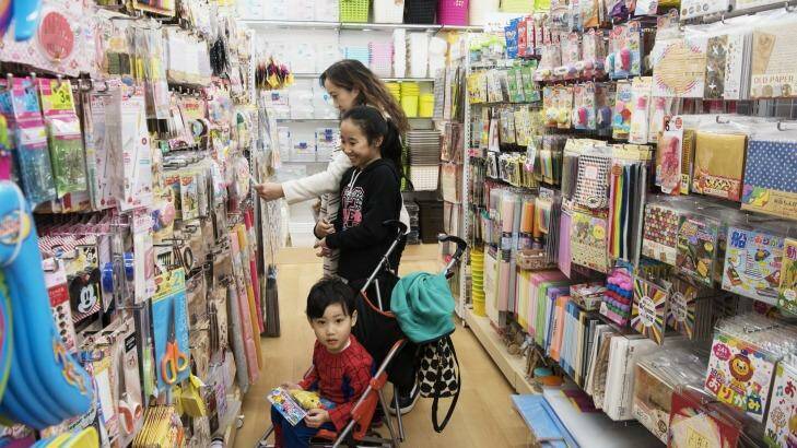 The Choy family browse products at Daiso's new store in Lidcombe. Photo: James Brickwood
