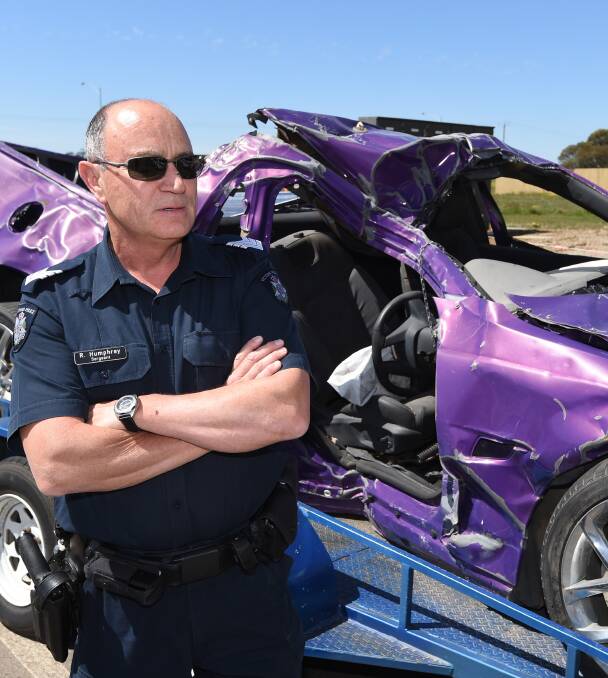 ROAD SAFETY: Ballarat Highway Patrol Sergeant Ross Humphrey next to the car brought up from Geelong to be on display this weekend. Picture: Lachlan Bence