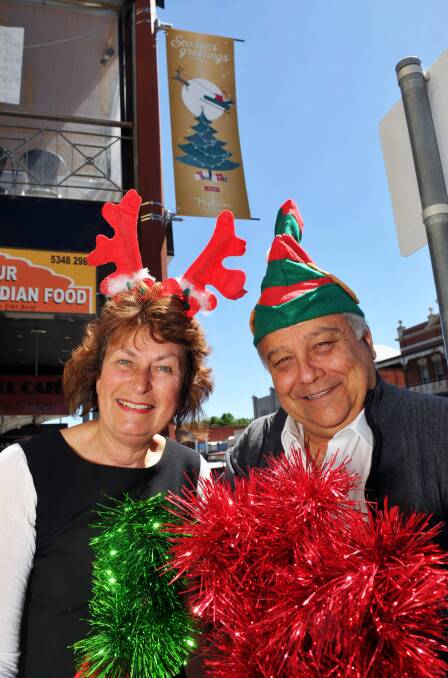 Hepburn Shire Mayor Kate Redwood and Cr Pierre Niclas showcase one of the new Christmas banners that span Vincent St. 