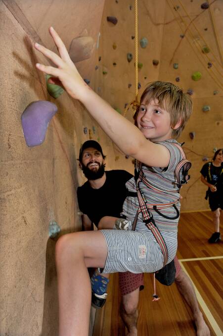 Escher Miller gets climbing instruction from rock wall instructor Byron Perry.
Picture: JULIE HOUGH