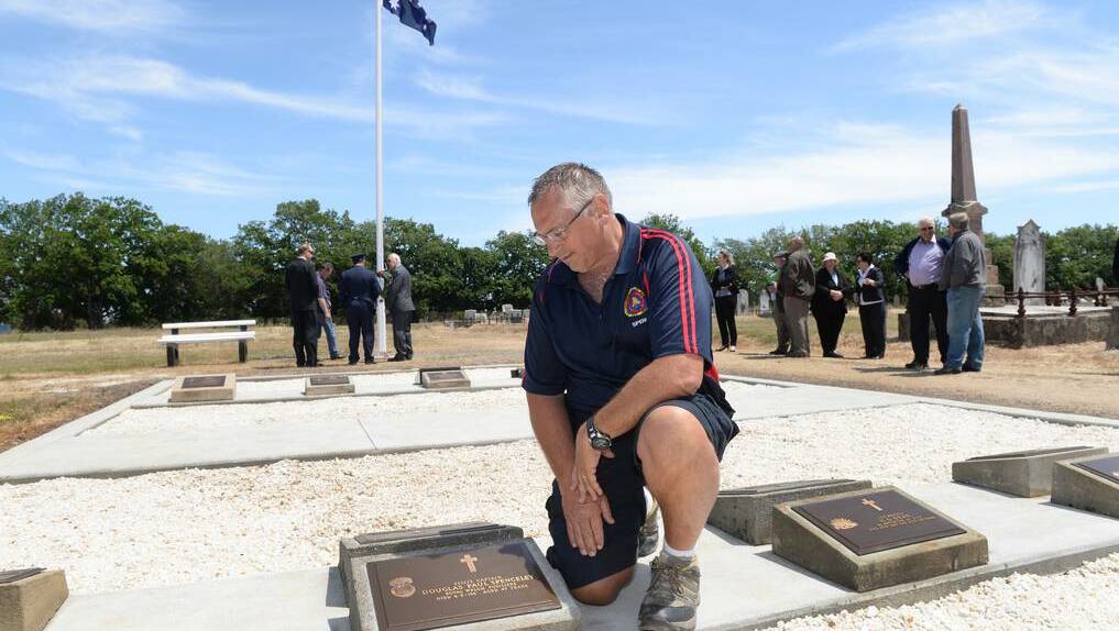 RENEWAL: Mark Spenceley at one of the refurbished headstones in the Creswick Cemetery's veterans section. PICTURE: KATE HEALY