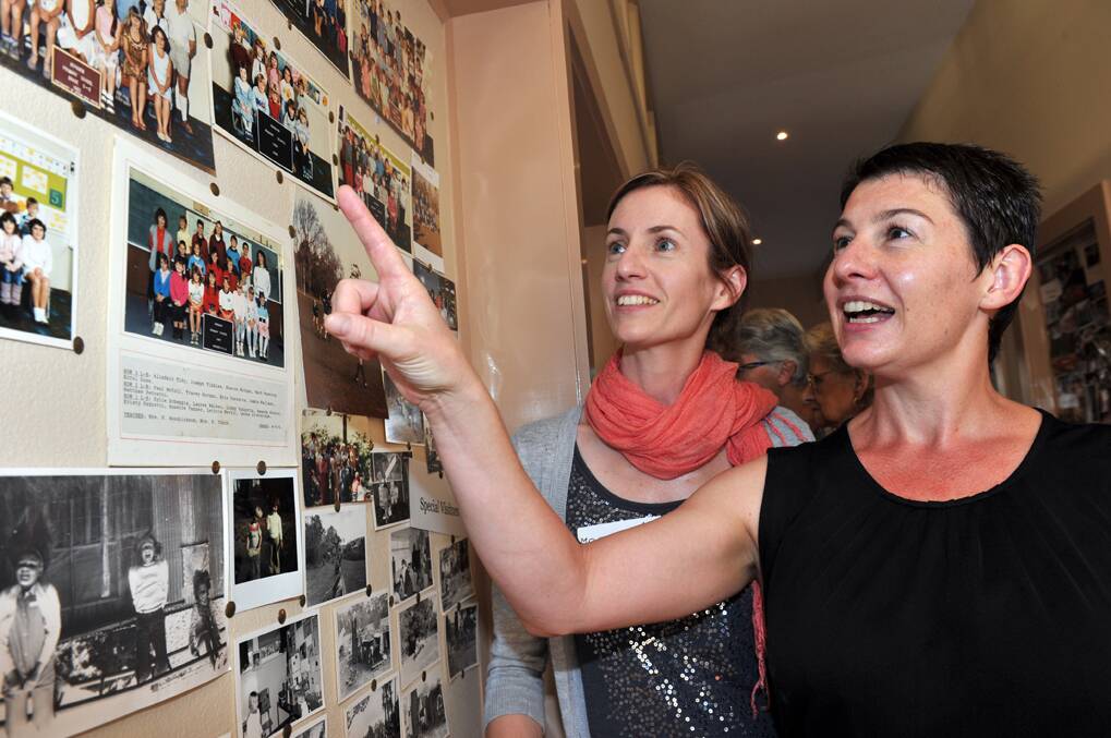 Melinda Quinn and Liss Stevens looking at their old class photos.

Picture: JULIE HOUGH 
