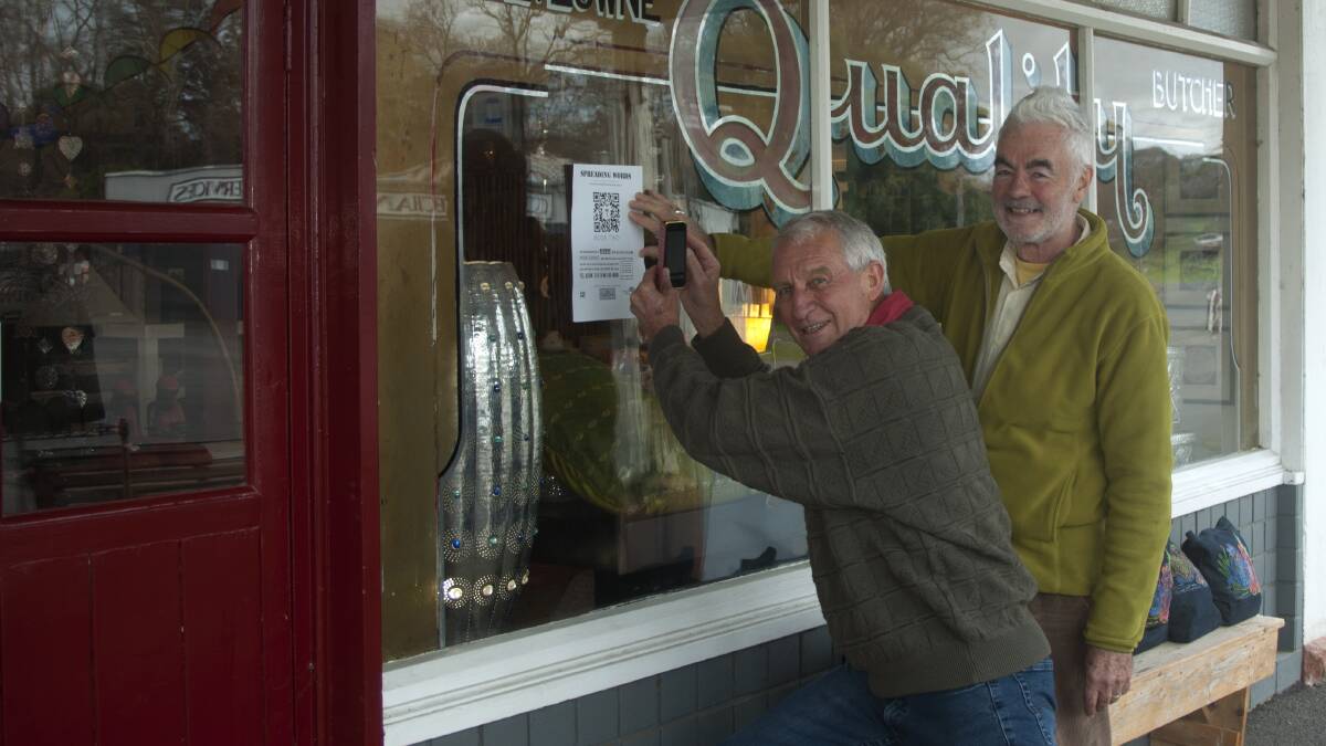 ONLINE HUNT: Doug Gellatly and Jon Lock test a QR code on the window of their business, Quince Farm Imports. Picture: CONTRIBUTED