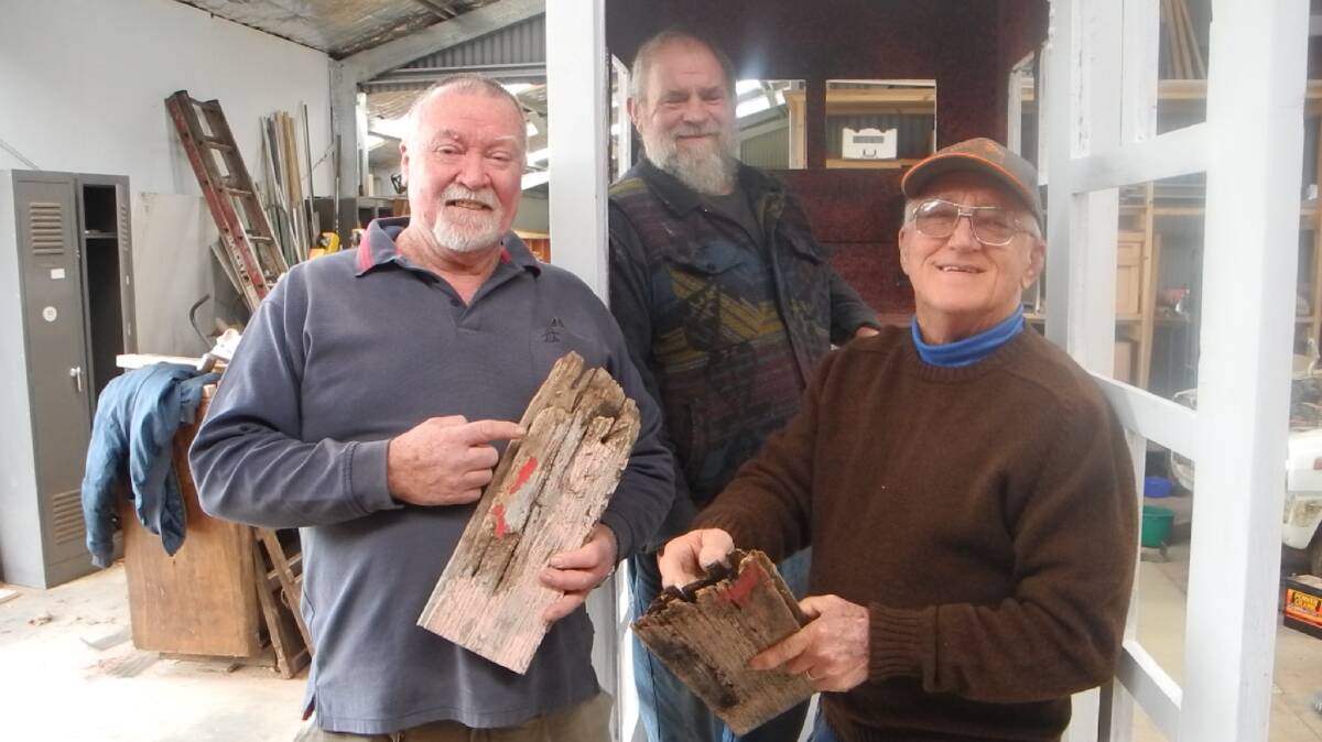 BETTER BOX:  Daylesford Men’s Shed secretary Colin Dunlop, Len Chidwick, and committee member Ken Ferguson with some of the wood from the old telephone box that has been replaced. Picture:  JULIE ATKINS