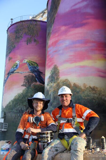 HARD WORK: Artists Joel Fergie (The Zookeeper) and Travis Vinson (Drapl) in front of the Thallon silos.