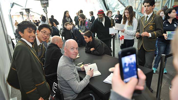 Authors John Boyne (right) and Morris Gleitzman meet young fans at Federation Square for the Melbourne Writers Festival.
