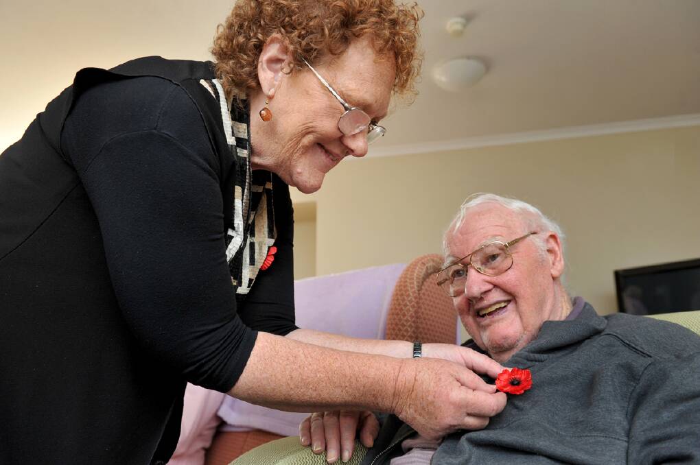 	 Remembrance Day Service at Trentham Aged Care Facility,Julie Hopkins pins a poppy on WW2 veteran Frank Lowe. : JULIE HOUGH