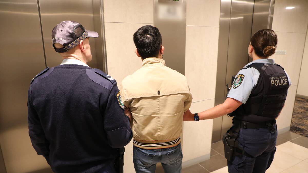 Police arrest a man in connection to the raids. Picture via NSW Police
