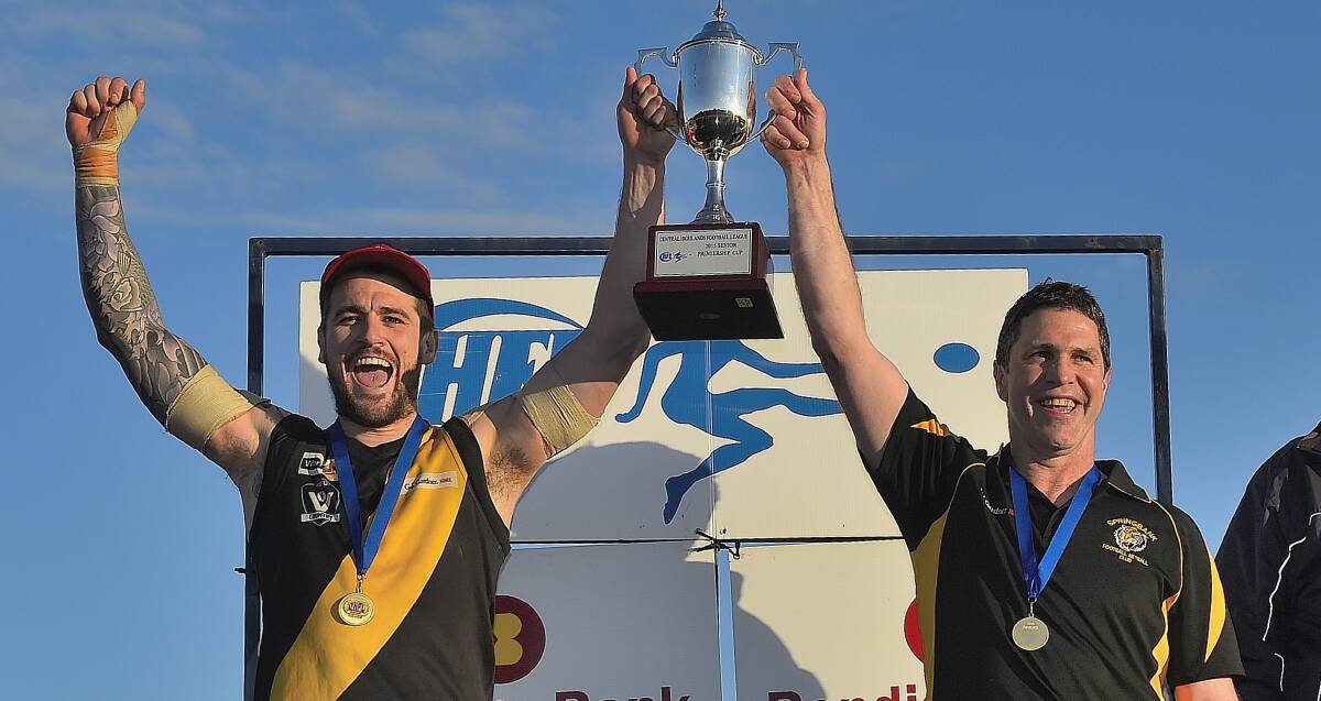 GONE: Springbank captain Chris Quinlan holds the 2015 premiership cup aloft with coach Terry Simpson. Both have since moved on.