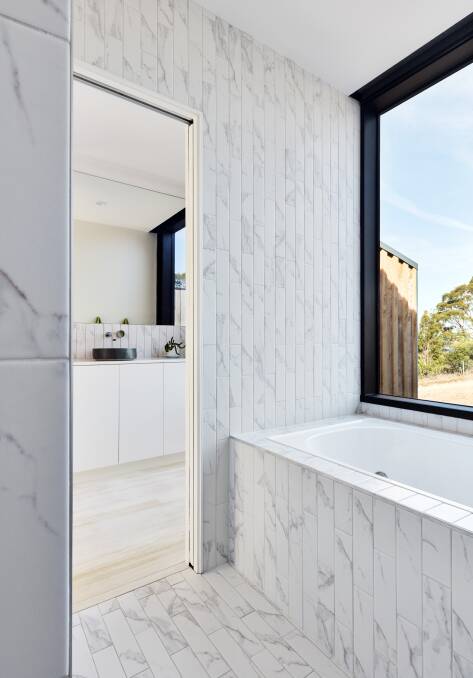 LEFT: The bathroom wet area features small marble tiles laid vertically.