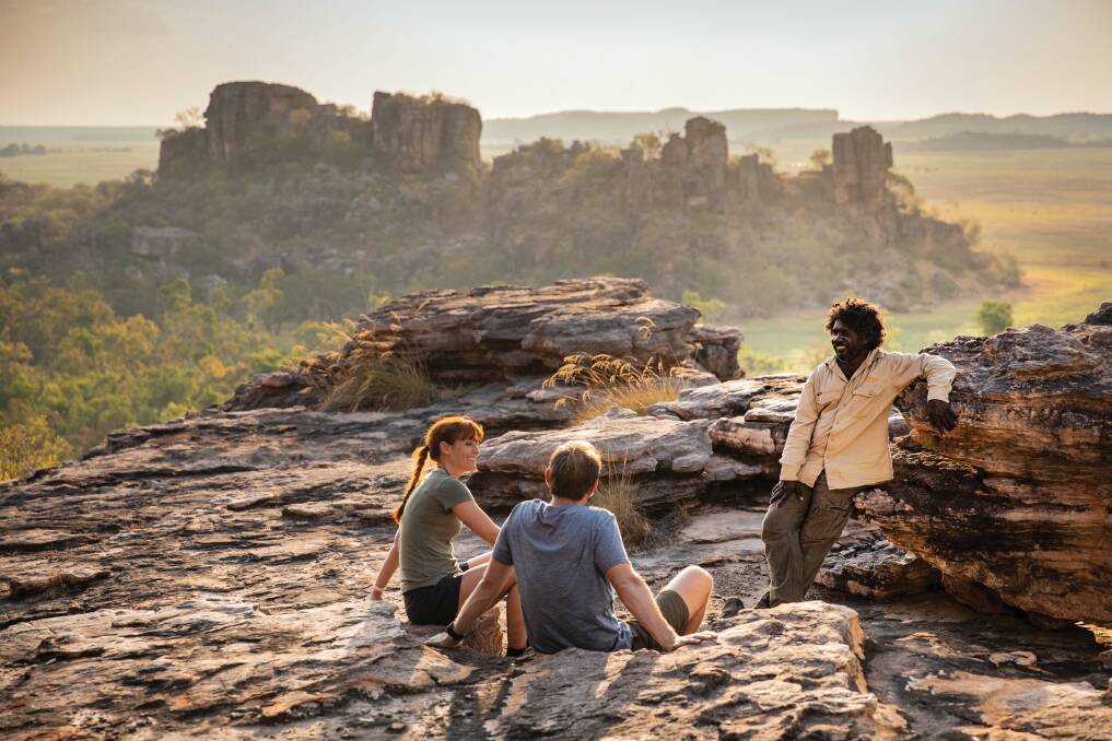Visitors looking over the Kakadu landscape with an Aboriginal guide from Kakadu Cultural Tours at Cannon Hill. Picture: Supplied