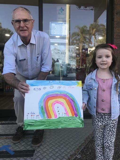Young artist Coco Buchanan with Steve Kennedy and her happy sign.
