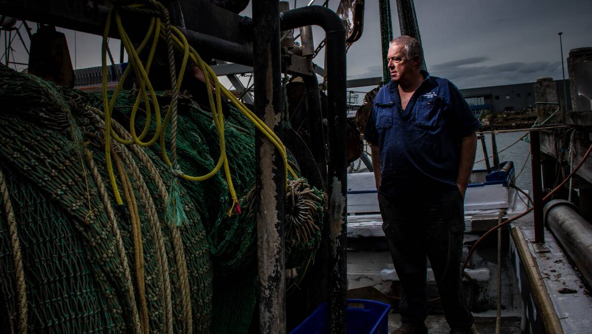 High and dry: Commercial fisherman Murray Ham repairing his boat Ellie-K yesterday after catching one of the submerged containers. Picture: Simon McCarthy