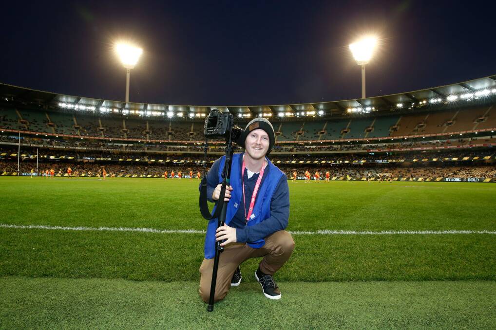 FOCUS: The Courier photographer Dylan Burns, pictured working AFL at the MCG, will join the IOC's young reporters programme. Picture: Adam Trafford