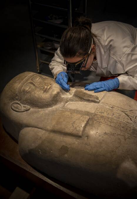 Preparing an Egyptian artefact for display at Sydney University's Chau Chak Wing Museum. Picture: Sydney University
