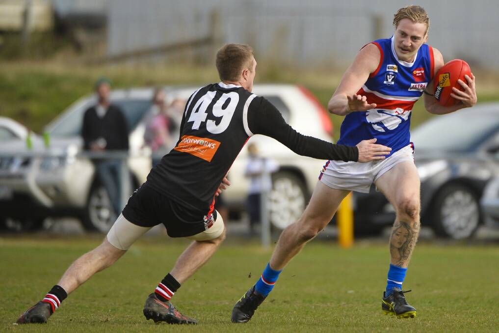 IN ACTION: Daylesford's Zac Tisdale avoids the tackle by Tyson Randall of the Creswick Wickers during the 2017 CHFL round 6 match. Picture: Dylan Burns