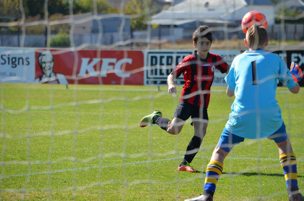EYES ON THE PRIZE: Daylesford Hepburn United Soccer under 13 player Zack Koleski kicks towards goals during the game against Sebastopol.