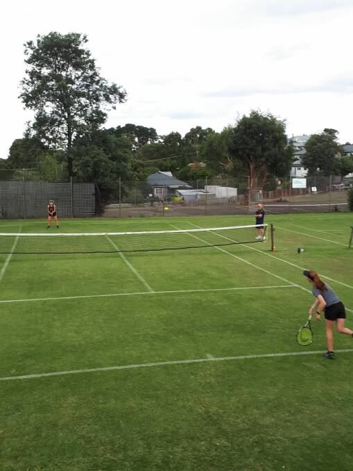 TOP SHOT: Olivia Leonard serving to Briony Ferrier in the u17 girls singles semi final at the Daylesford Lawn Tennis Club.