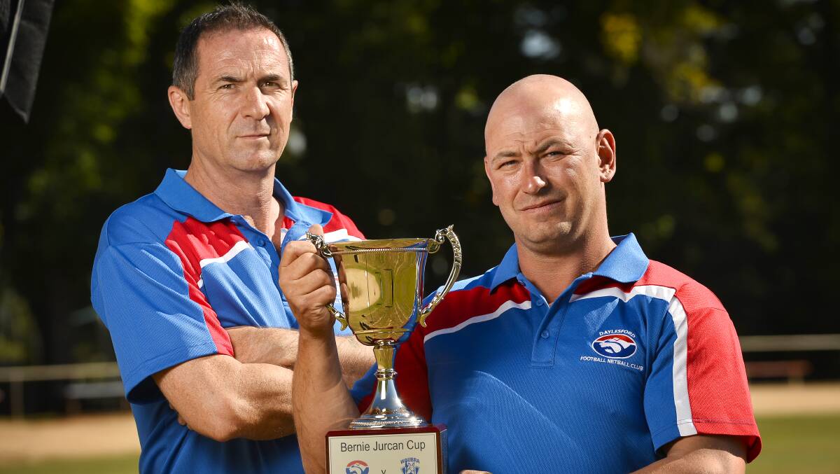 Remembering a great: Daylesford Football Club president Guy McLeod and club champion Joel Adams inspect the new Bernie Jurcan Cup which will be up for grabs in round three against Waubra.  Picture: Dylan Burns. 