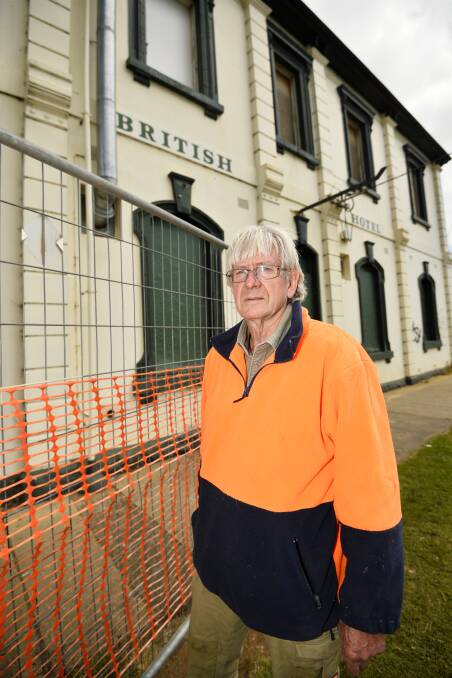 Fenced off: Creswick Ward councillor Don Henderson inspecting the state of the British Hotel on Albert Street. Picture: Dylan Burns 