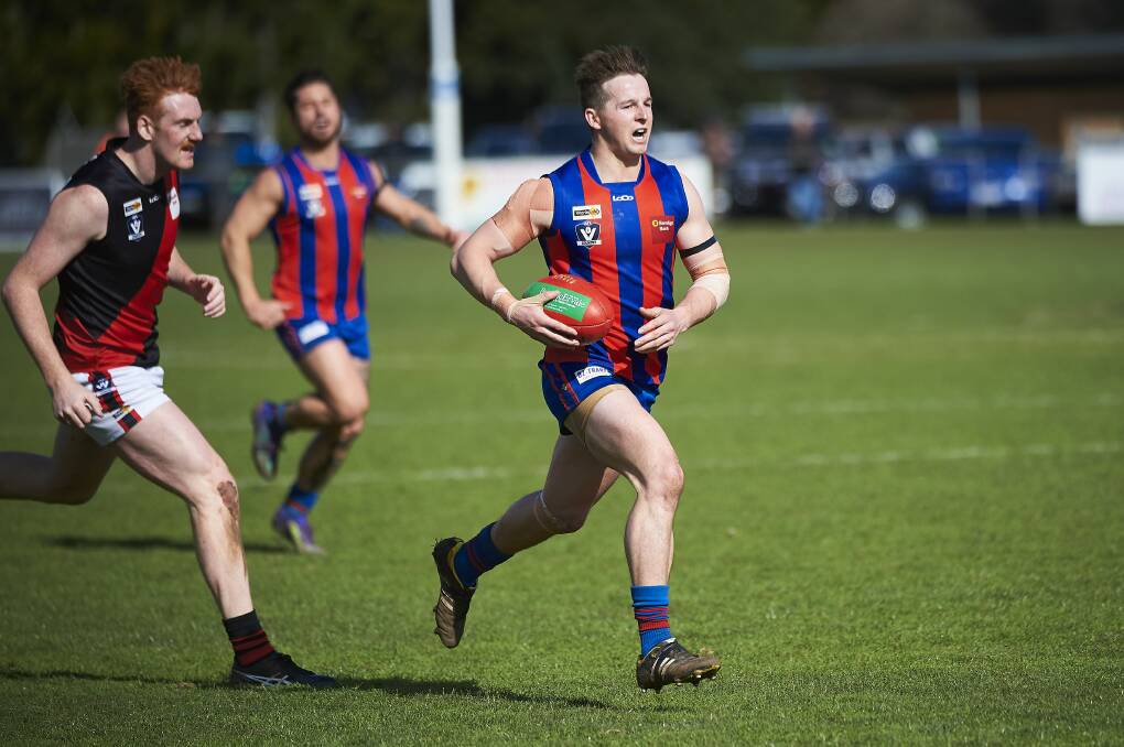 ON THE CHARGE: Hepburn's Brad McKay sends his team forward during Sunday's hard-fought victory against Buninyong. Pictures: Luka Kauzlaric