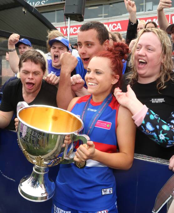 THAT WINNING FEELING: Jenna Bruton celebrates the Western Bulldogs' six-point grand final win over the Brisbane Lions on Saturday. Bruton was named in her team's best for a 13-disposal performance.