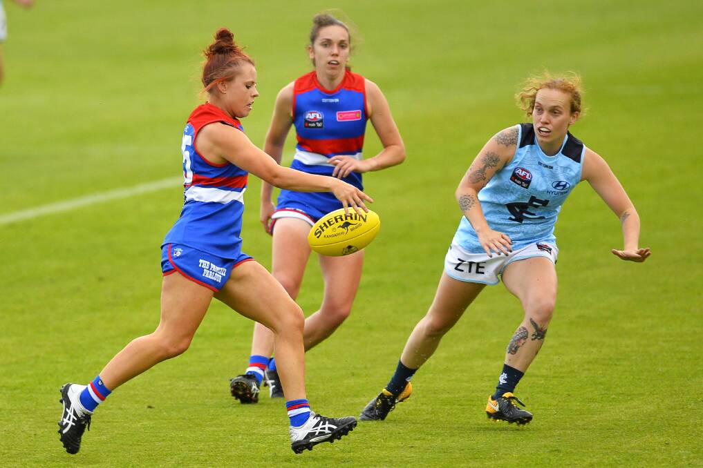 NEW COLOURS: Western Bulldogs recruit Jenna Bruton, who is from Trentham, gets a kick away in Ballarat on Saturday evening. Picture: Dylan Burns